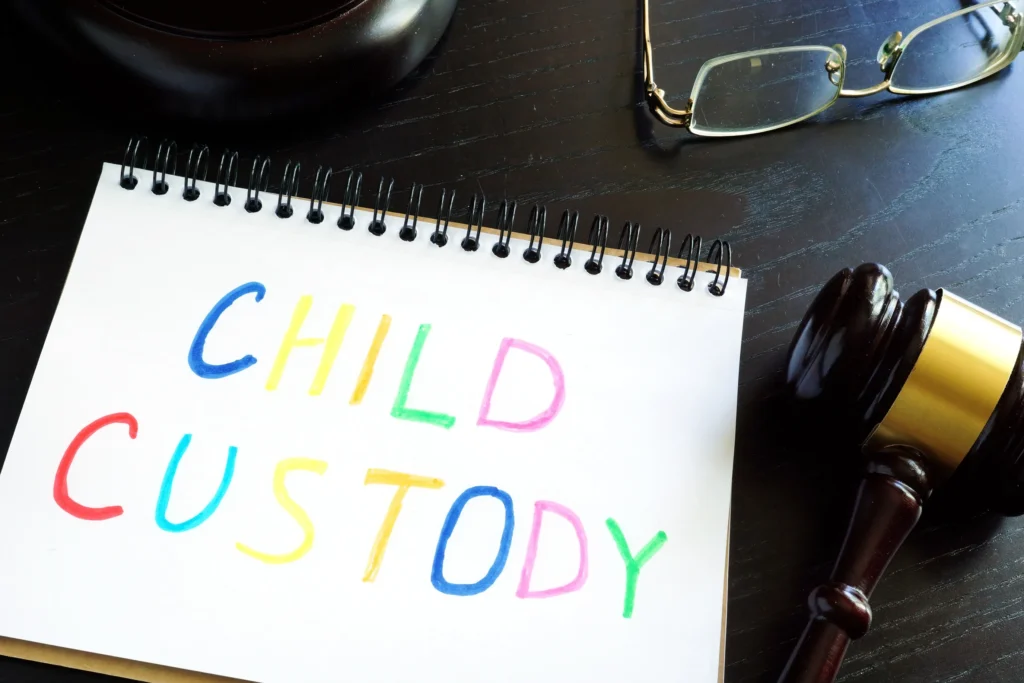 A note pad with the words 'child custody' written in multi color markers.