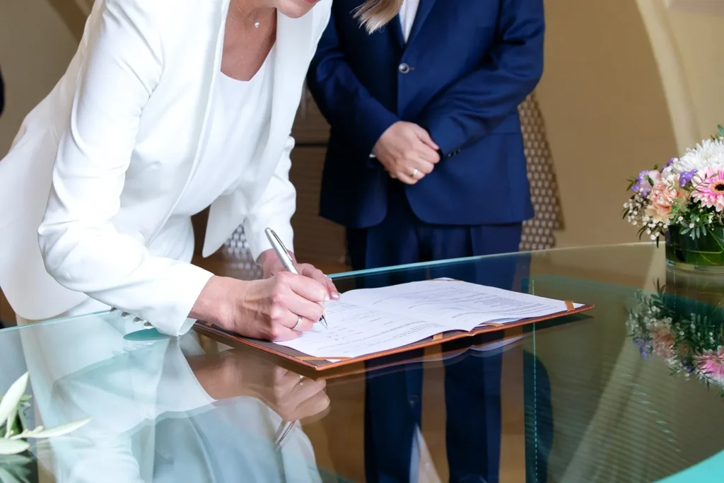 A woman signing divorce papers.