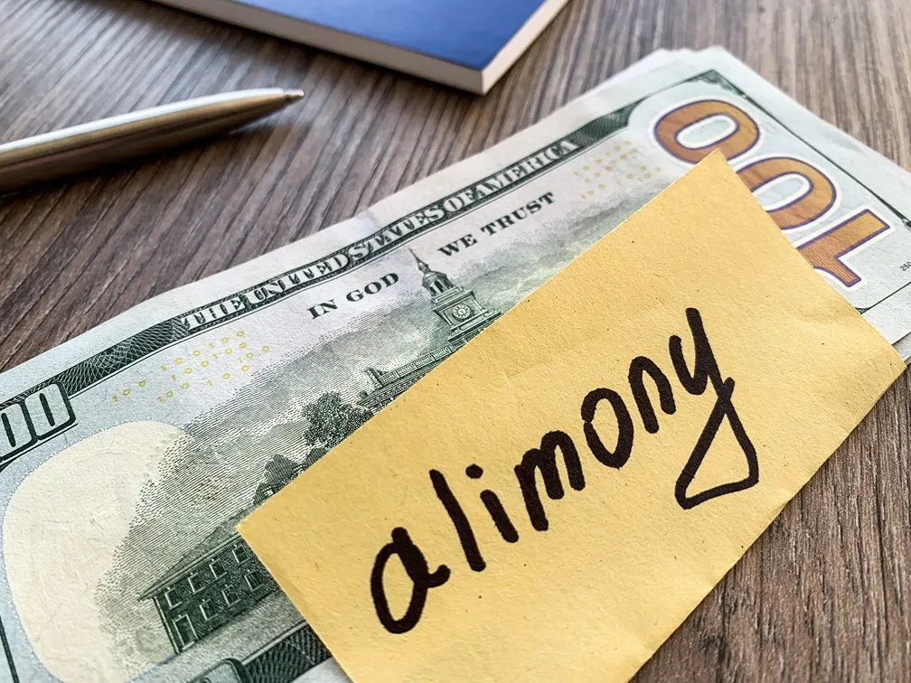 A one-hundred dollar bill with a note saying 'alimony'.