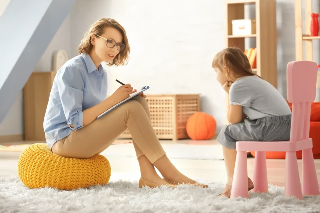 Child talking to a caseworker or counselor in a home setting, representing CPS investigations and reasons for child removal.